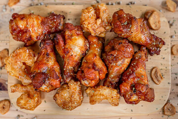 BBQ chicken drumsticks grilled on wooden floor