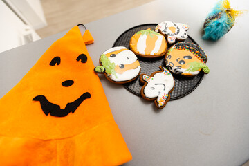 Master class for children on baking funny halloween cookies. Young children learn to cook a funny monster cookies. Kids preparing homemade cookies. Little cook.
