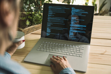 Freelancer computer programmer working on laptop at home