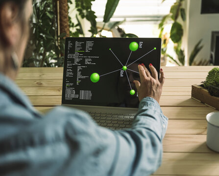 Freelancer pinching diagram on laptop screen at home