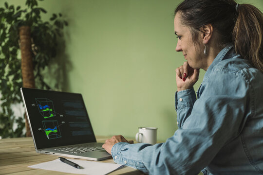 Smiling freelancer working on laptop at home