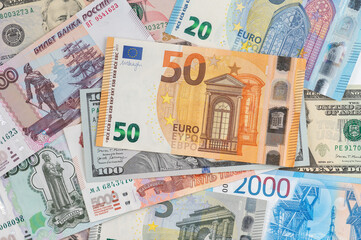 Money from different countries: dollars, euros, rubles. International currencies background.