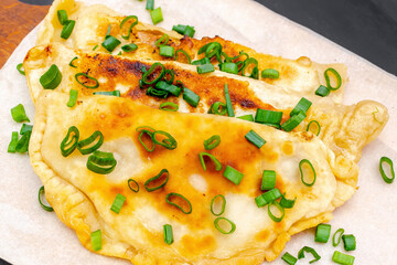 Uzbek,Tatar cuisine,cheburek with beef,pork meat,onions,greens on wooden board.Fresh baked homemade Cornish pasties,fried stews pie wrapped in shortcrust pastry.Traditional Turkish mongolian dish