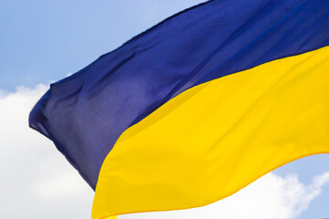 Fototapeta na wymiar Ukraine flag isolated on the blue sky with clipping path. close up waving flag of Ukraine. flag symbols of Ukraine