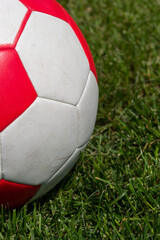Fototapeta na wymiar Soccer ball on green grass of football field with copy space