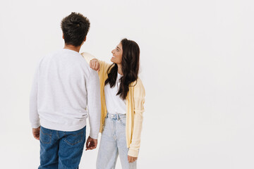 East asian young man and woman smiling and posing at camera