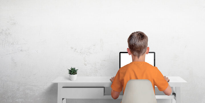 Boy Typing On A Laptop Computer. The Concept Of Sending An Email Or Corresponding With Friends. Protection Of Privacy Of Minors