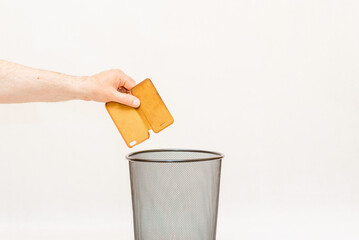 The phone case is thrown into the trash,can for disposal and recycling.White,gray...