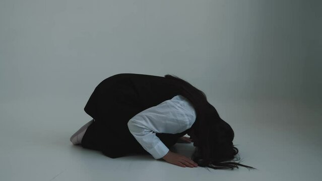 Woman prays on her knees. Prayer or meditation, turning to god, faith concept.