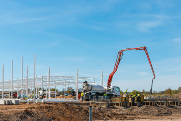 Urban area with machinery, car cement mixer,people are working on construction...