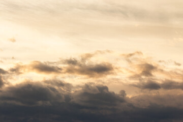 clouds on the sky in golden hour light. warm weather in summer at sunset