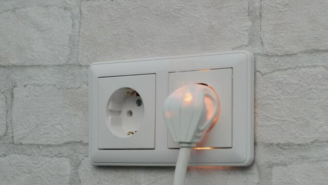 Ignition of outlet during short circuit in apartment close up. Concept fire from electrical appliances malpractice.