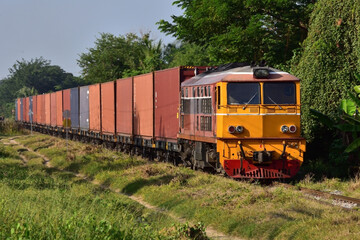 Fototapeta na wymiar Thai container freight-train by diesel locomotive on the railway.