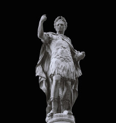 Stone Statue of Caesar or a Roman centurion in a display of strength and power. Isolated on black background.