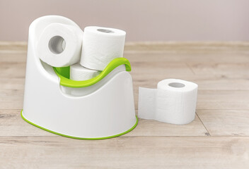 Baby potty with toilet paper inside.