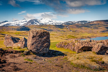Big boulder on the shore of Icelendic lake. Amazing summer scene of south Iceland with volcanic...