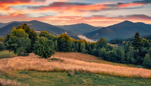 Panoramic summer view of Lacul Dragan lake. Magnificent sunrise in Cluj County, Romania. Astonishing morning scene of Apuseni Mountains. Beauty of countryside concept background..