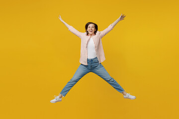 Fototapeta na wymiar Full body young happy exultant jubilant fun woman she 30s wears striped shirt white t-shirt jump high with outstretched hands legs isolated on plain yellow background studio. People lifestyle concept.