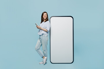 Full size young happy woman she 30s in casual blouse big huge blank screen mobile cell phone with...
