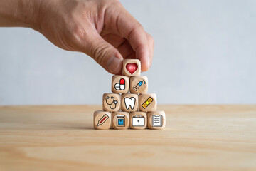 Medical icon on pyramid of cubes. medicine and health insurance concepts. Wooden blocks with icons of various types of insurance, icons healthcare medical