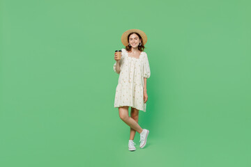 Full body young happy woman she 20s wears white dress hat hold takeaway delivery craft paper brown cup coffee to go isolated on plain pastel light green background studio. People lifestyle concept