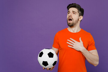 Young man fan wears basic orange t-shirt cheer up support football sport team holding in hand...