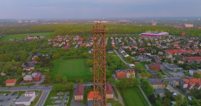 Aerial view of the wooden broadcasting tower in Gliwice with the city of Gliwice in the background. The concept of the largest wooden tower in the world. Wooden construction from a drone.
