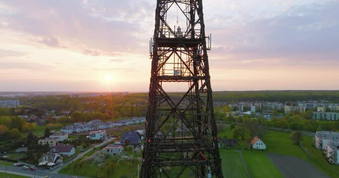 Aerial view of the wooden broadcasting tower in Gliwice with the city of Gliwice in the background. The concept of the largest wooden tower in the world. Wooden construction from a drone.