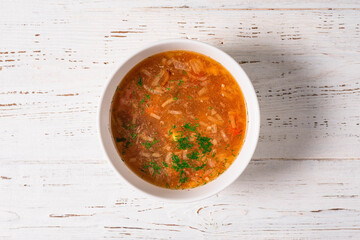 soup in a plate on a white wooden background