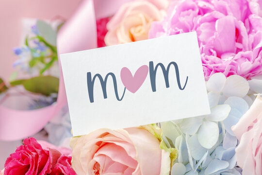Mom text with heart on card with beautiful flower background, mother day greeting card