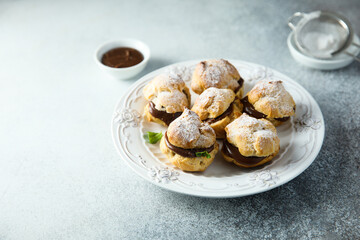 Homemade profiteroles with chocolate paste
