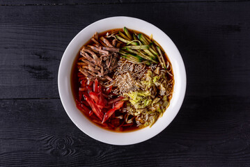 kuksi is a Korean national dish. on a black wooden background