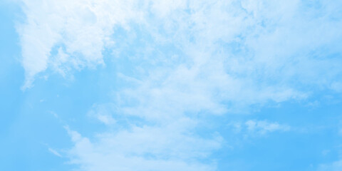 Abstract clear view of natural cloudy sky of winter seasons, Cloudy and bright shinny blue sky background with white clouds, fluffy and blurry summer sky background for wallpaper and design.