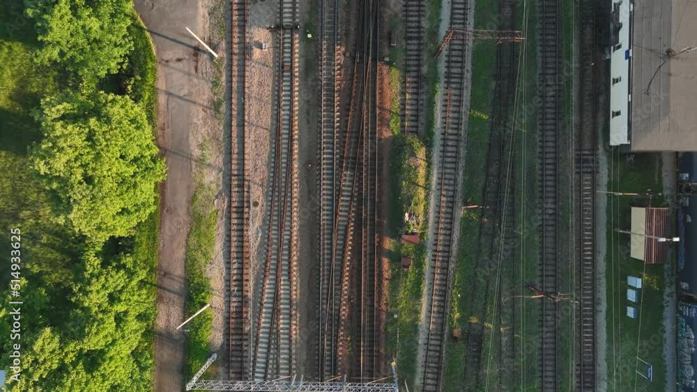 Poster the view from the drone on the railroad tracks against the background of the setting sun. concept of