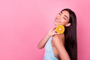 Photo of cute lady hold mandarin empty space enjoy cosmetology gel with fruity ingredient isolated pastel color background
