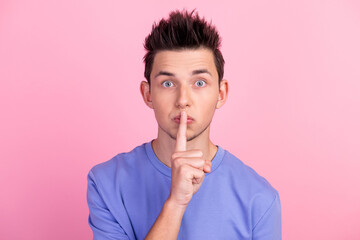 Portrait of handsome guy finger covering lips shh sign dont talk isolated on pastel color background