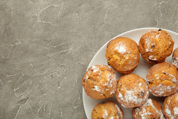 Vanilla muffins. Sweet cupcakes on white plate. Top view.