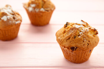 Vanilla muffins. Sweet cupcakes on pink background.