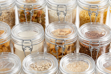 food storage, culinary and storage concept - jars with different cereals or groceries on table