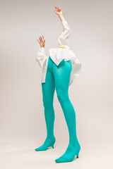 Contemporary art portrait of young emotional girl in bright cyanic tights isolated over white...