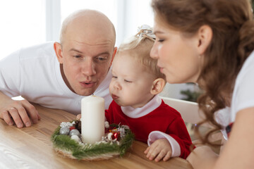 Baby child with hearing aid and cochlear implant having fun with parents in christmas room. Deaf ,...