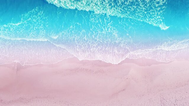 Beautiful sunset rose sand beach. Aerial view of ocean waves breaking on a tropical sandy beach.