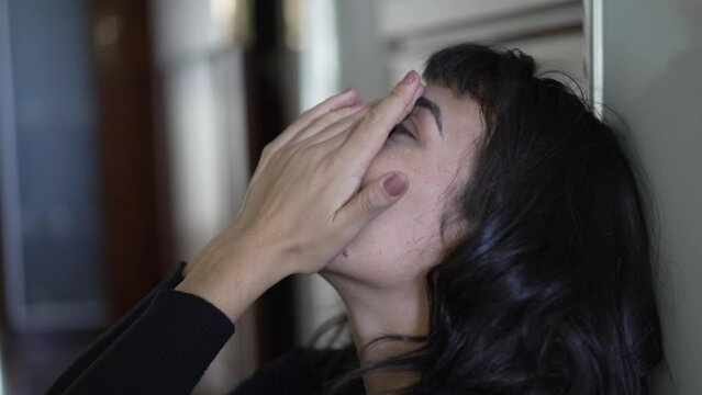 Closeup of young woman face feeling regret. Person taking deep breath and discomfort on previous past mistakes