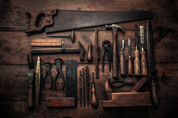 table top view of carpenter workbench full of old rusty tools
