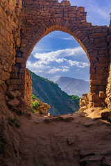 beautiful stone arch in the ruins of the abandoned ancient village of Gamsutl, Dagestan