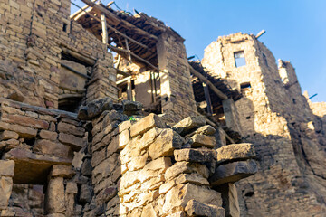 ruined old high stone houses in the abandoned village of Gamsutl, Dagestan