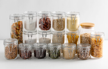 food storage, culinary and storage concept - jars with different cereals or groceries on table