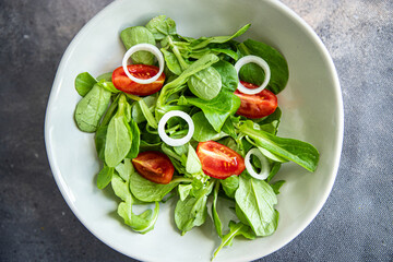 green salad vegetable tomato, onion, lettuce mix, mache green fresh healthy meal food snack diet on the table copy space food background rustic top view 