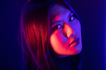 Stylish sexy woman in trendy. Beautiful young asian woman standing pose with neon light. Asia...