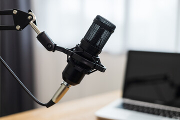 Condenser microphone in recording home studio. Content creator working with laptop host streaming radio podcast interview conversation at home broadcast studio recording voice over radio